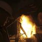 An engineer covers his face as workers pour molten iron into a container at a factory belonging to Ezz Steel, Egypt's largest steel producer, at an industrial complex in Sadat City, 94 km (58 miles) north of Cairo, April 17, 2013. REUTERS/Amr Abdallah ...