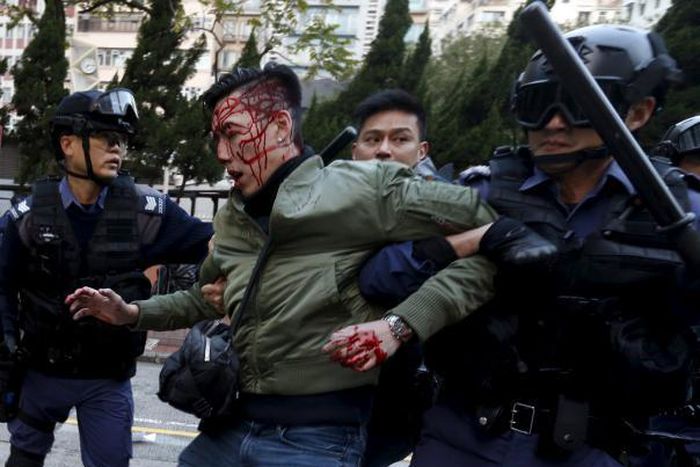 Hong Kong riot police fire warning shots in bloody street clashes