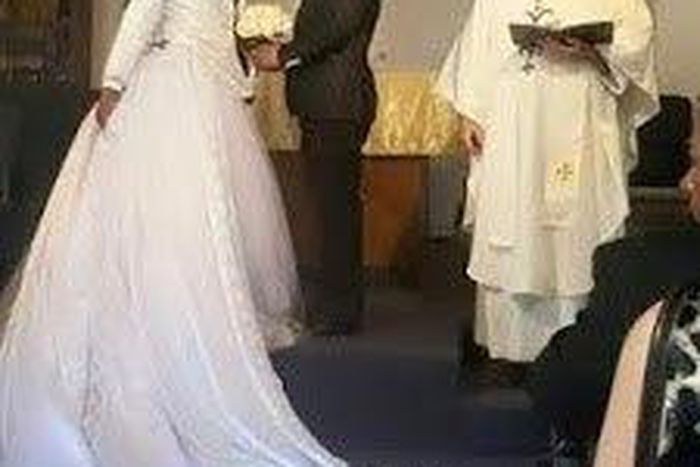 Groom wears dress train on suit for gay wedding