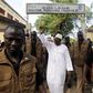 Incumbent president Alpha Conde, leader of Rassemblement du Peuple de Guinea (RPG), wavess as he leaves the polling station during a presidential election in Conakry, Guinea October 11, 2015. REUTERS/Luc Gnago