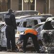 Gendarmes inspect burnt-out vehicles outside the Splendid Hotel in Ouagadougou, Burkina Faso, January 16, 2016, after security forces retook the hotel from al Qaeda fighters who seized it in an assault that killed two dozen people from at least 18 coun...