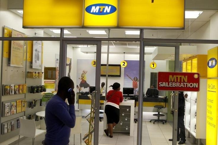 A man speaks on a mobile phone as he walks past a MTN shop at a shopping mall south of Johannesburg June 6, 2012. REUTERS/Siphiwe Sibeko