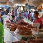 A vendor sells traditional cakes of fried honey and flour pastries to customers during the first day of Ramadan in the medina of the Moroccan city of Oujda June 18, 2015. REUTERS/Youssef Boudlal