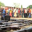 Suspected fighters are paraded before the media by Burundian police near a recovered cache of weapons after clashes in the capital Bujumbura, Burundi December 12, 2015. REUTERS/Jean Pierre Aime Harerimana