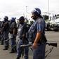 Police officers stand guard to prevent protesters from proceeding with their march in Rustenburg, South Africa's North West Province September 16, 2012. REUTERS/Siphiwe Sibeko
