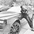 Sound Sultan leaning on a Rolls Royce Phantom