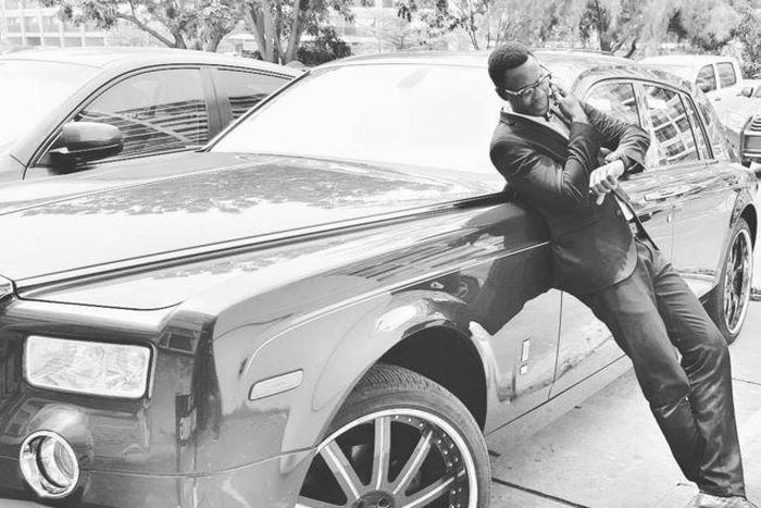 Sound Sultan leaning on a Rolls Royce Phantom