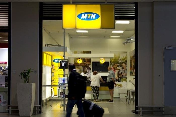 Travellers walk past an MTN telecom shop at King Shaka International Airport in Durban, South Africa, November 16, 2015. REUTERS/Rogan Ward