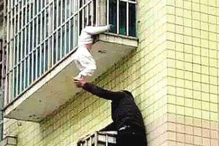 Strangers save child found dangling by its neck from 3rd floor balcony