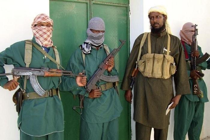 Sheik Muktar Robow Abu Mansur (2nd R), spokesman of Somalia's Islamic al-Shabab, leaves a news conference after vowing to step up attacks against government soldiers and foreign troops in a file photo. REUTERS/Feisal Omar
