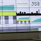 People chat in front of an electronic board displaying movements in major indices at the Johannesburg Stock Exchange building in Sandton Johannesburg July 9, 2015. REUTERS/Siphiwe Sibeko