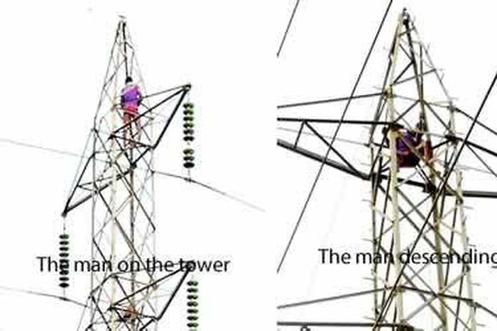 Man climbs high tension tower