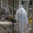Health workers push a wheeled stretcher holding a newly admitted Ebola patient in a file photo. REUTERS/Baz Ratner
