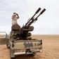 A Libyan soldier looks through binoculars at Wadi Bey, where troops are manning outposts, west of the Islamic State-controlled city of Sirte, February 23, 2016. REUTERS/Ismail Zitouny