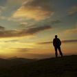 Male silhouette watching the rising sun