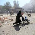 A woman pushes a baby stroller as she rushes away after what activists said were airstrikes by forces loyal to Syria's President Bashar al-Assad on a busy marketplace in Douma, near Damascus, Syria August 12, 2015.