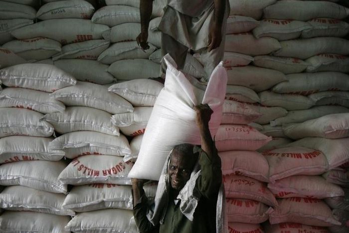 A man unloads a sack of sugar from a warehouse supply in Karachi April 10, 2010. REUTERS/Athar Hussain