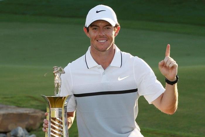 Rory McIlroy celebrates with the trophy after winning The Race to Dubai