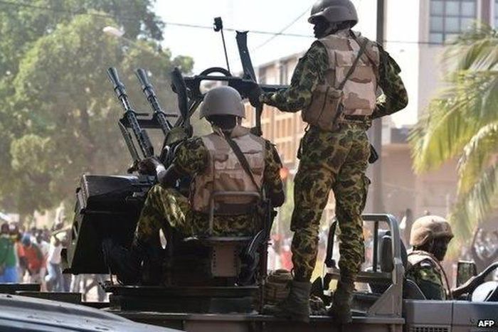 Burkina Faso troops try to disperse protesters in Ouagadougou on 30 October 2014.