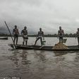 Cameroonian artisanal miners go diving in the Wouri river an average of 100 times a day for wet sand [Hugh Brown/SWNS.com]