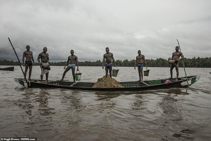 Cameroonian artisanal miners go diving in the Wouri river an average of 100 times a day for wet sand [Hugh Brown/SWNS.com]