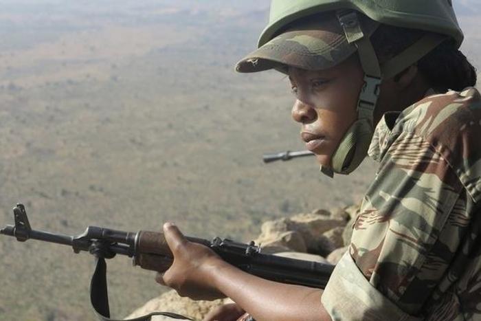A female Cameroonian soldier stands guard at an observation post on a hill in the Mandara Mountain chain in Mabass, overlooking Nigeria, northern Cameroon, February 16, 2015. REUTERS/Bate Felix Tabi Tabe