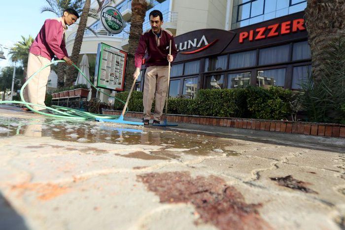 Cleaners try to clean blood stains near the entrance to Bella Vista Hotel in the Red Sea resort of Hurghada, Egypt, January 9, 2016. Two armed assailants attacked a hotel in the Egyptian Red Sea resort town of Hurghada on Friday, wounding three foreign...