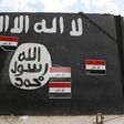A wall painted with the black flag commonly used by Islamic State militants, near former Iraqi president Saddam Hussein's palace in Tikrit April 1, 2015.