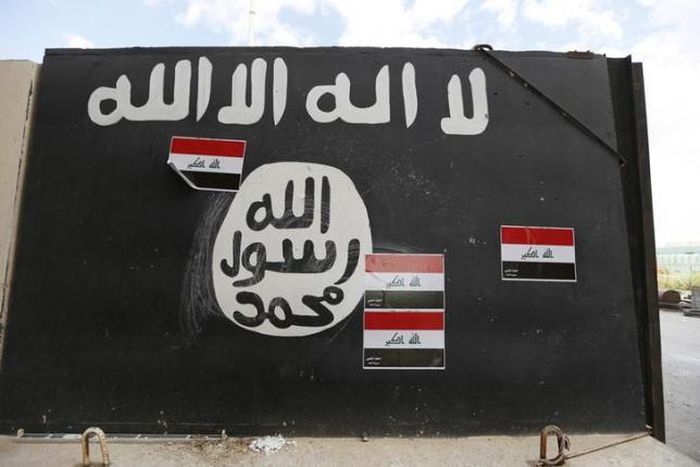 A wall painted with the black flag commonly used by Islamic State militants, near former Iraqi president Saddam Hussein's palace in Tikrit April 1, 2015.
