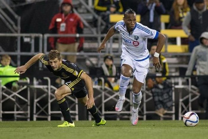 Columbus, OH, USA; Montreal Impact forward Didier Drogba (11) dribbles the ball while Columbus Crew SC defender Gaston Sauro (22) defends during the extra time in the game at MAPFRE Stadium. Columbus beat Montreal in extra time 4-3 on aggregate. Credit...