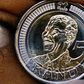 Nthombi Kwena holds a 5 rand coin minted to commemorate former South African president Nelson Mandela's 90th birthday in Johannesburg July 7, 2008. REUTERS/Juda Ngwenya