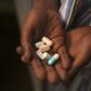 Nine-year-old Tumelo shows off antiretroviral (ARV) pills before taking his medication at Nkosi's Haven, south of Johannesburg November 28, 2014. REUTERS/Siphiwe Sibeko