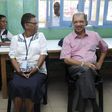 Seychelles President James Michel (R) talks to lawyer Alexia Antao at a voting centre during the presidential polls in Victoria, Seychelles, December 3, 2015.