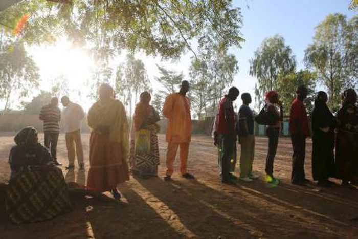 People queue to vote during the presidential and legislative election at a polling station in Ouagadougou, Burkina Faso, November 29, 2015.