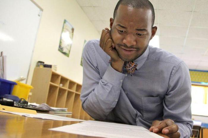 Teacher Omar Currie reads a copy of a complaint a parent filed about him reading the book "King & King to his students