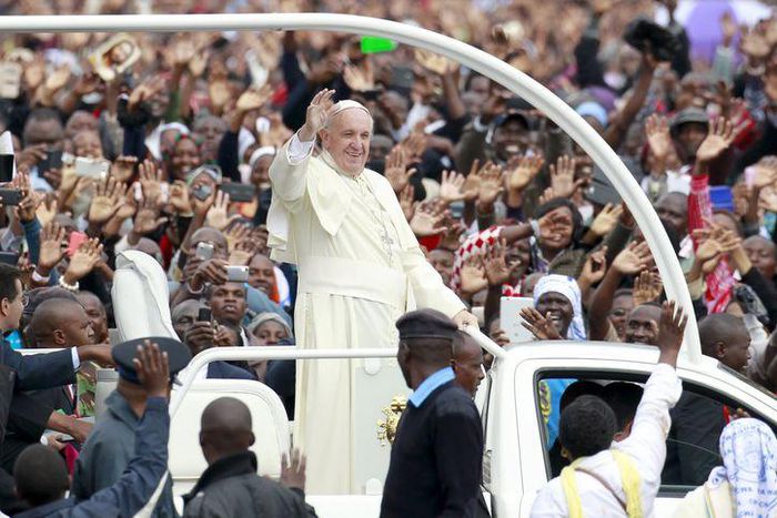 Pope Francis waves to faithful while riding in an open truck as he arrives for a Papal mass in Kenya's capital Nairobi, November 26, 2015. REUTERS/Thomas Mukoya