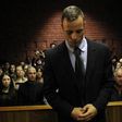 Oscar Pistorius stands in the dock ahead of court proceedings at the Pretoria magistrates court February 22, 2013.