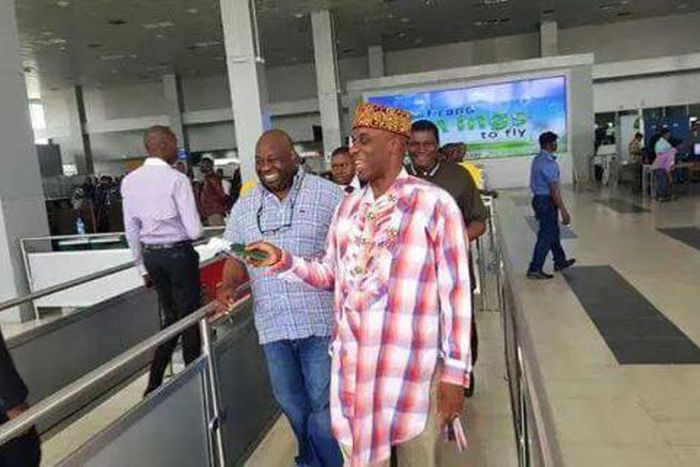 Transport Minister, Rotimi Amaechi takes off shoes at Murtala Mohammed International Airport on December 3, 2015