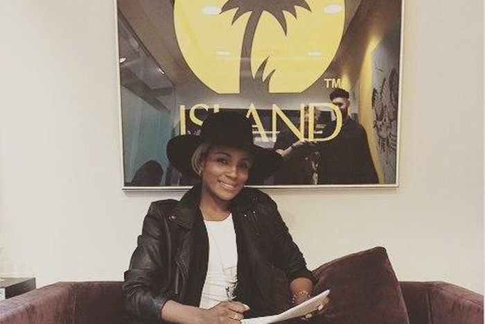 Seyi Shay is all smiles as she seals her new contract with the music giants.