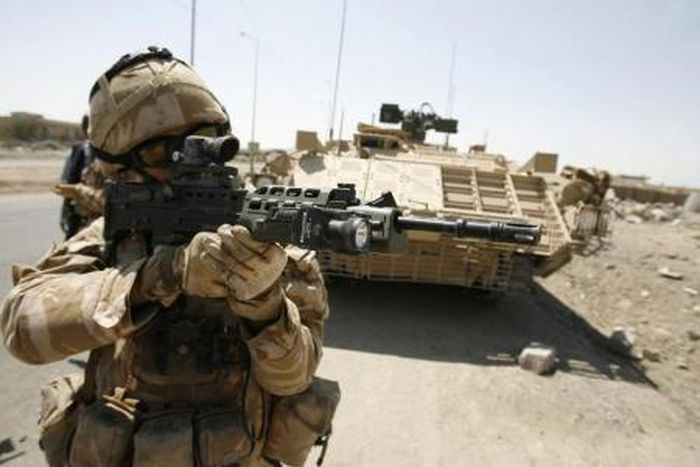 A British soldier looks through the scope of his rifle after a roadside bomb attack that targeted their convoy in Basra, 420 km (260 miles) northeast of Baghdad,in this file photo from September 12, 2008.