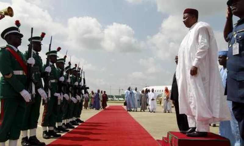Niger"s President Mahamadou Issoufou inspects the guard of honour upon arrival at the airport in Abuja, Nigeria May 28, 2015.