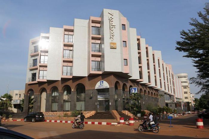 People drive motorcycles past the Radisson Blu hotel in Bamako, Mali, November 22, 2015. REUTERS/Joe Penney