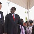 Chinese President Xi Jinping talks with Zimbabwean President Robert Mugabe on arrival for a state visit in Harare, Zimbabwe December 1, 2015. REUTERS/Philimon Bulawayo