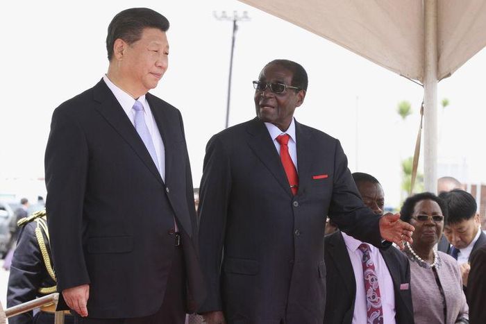 Chinese President Xi Jinping talks with Zimbabwean President Robert Mugabe on arrival for a state visit in Harare, Zimbabwe December 1, 2015. REUTERS/Philimon Bulawayo