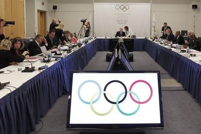 International Olympic Committee President Jacques Rogge and members of the IOC talk prior to the beginning of the IOC executive board meeting at the SportAccord convention at the Congress Center in Quebec City, in a file photo. REUTERS/Mathieu Belanger