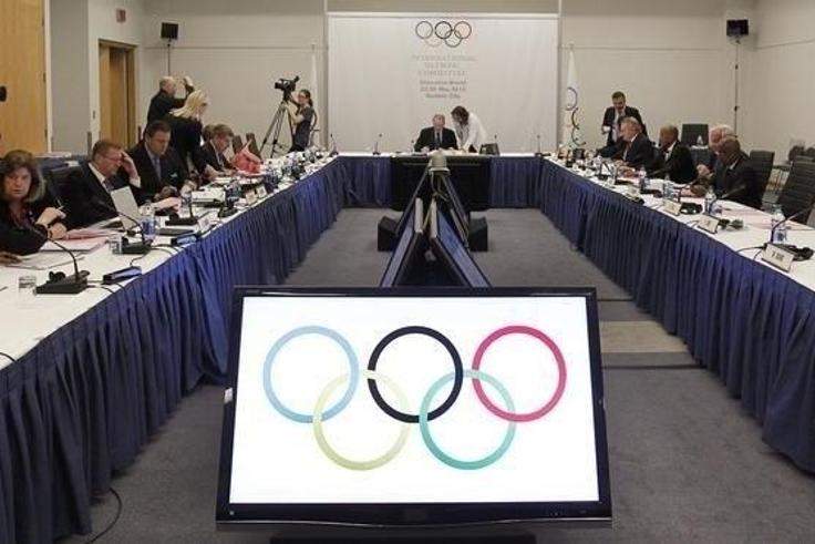 International Olympic Committee President Jacques Rogge and members of the IOC talk prior to the beginning of the IOC executive board meeting at the SportAccord convention at the Congress Center in Quebec City, in a file photo. REUTERS/Mathieu Belanger