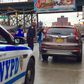 NYPD officer stopping a car to hand out gifts