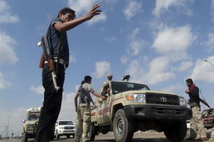 Members of the pro-government Popular Committees militia man a checkpoint at an entrance of Yemen"s southern port city of Aden December 3, 2015.