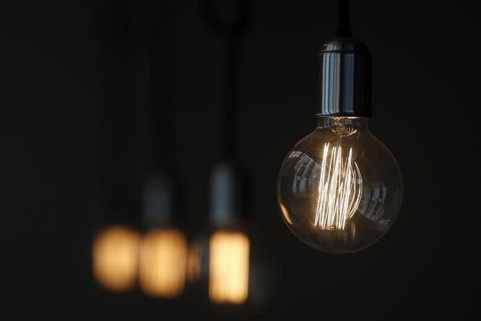 A bulb hangs inside a restaurant in Madrid December 23, 2013. REUTERS/Andrea Comas