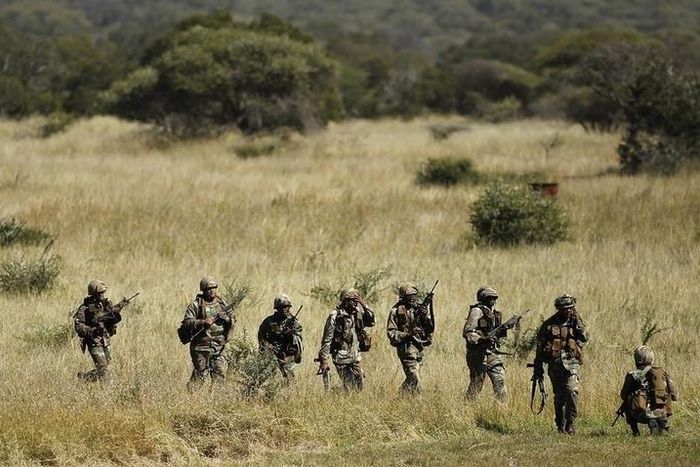 Members of the South African National Defence Force (SANDF) return after taking part in a Capability Demonstration at the Roodewal Bombing Range in Makhado, in the northern province of Limpopo, May 9, 2013. REUTERS/Siphiwe Sibeko